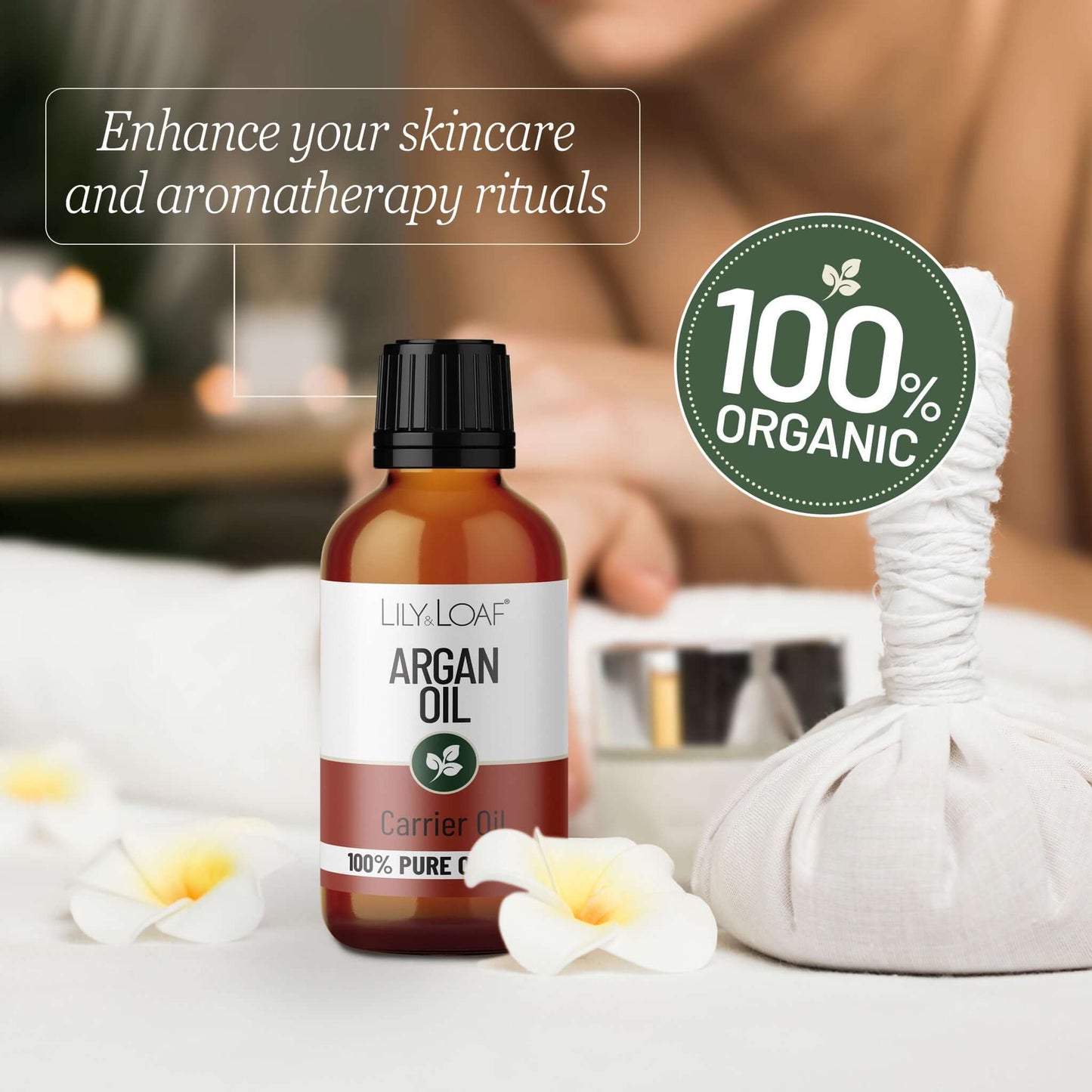 Bottle of argan oil with a 100% organic label on a blurred background of a spa setting.