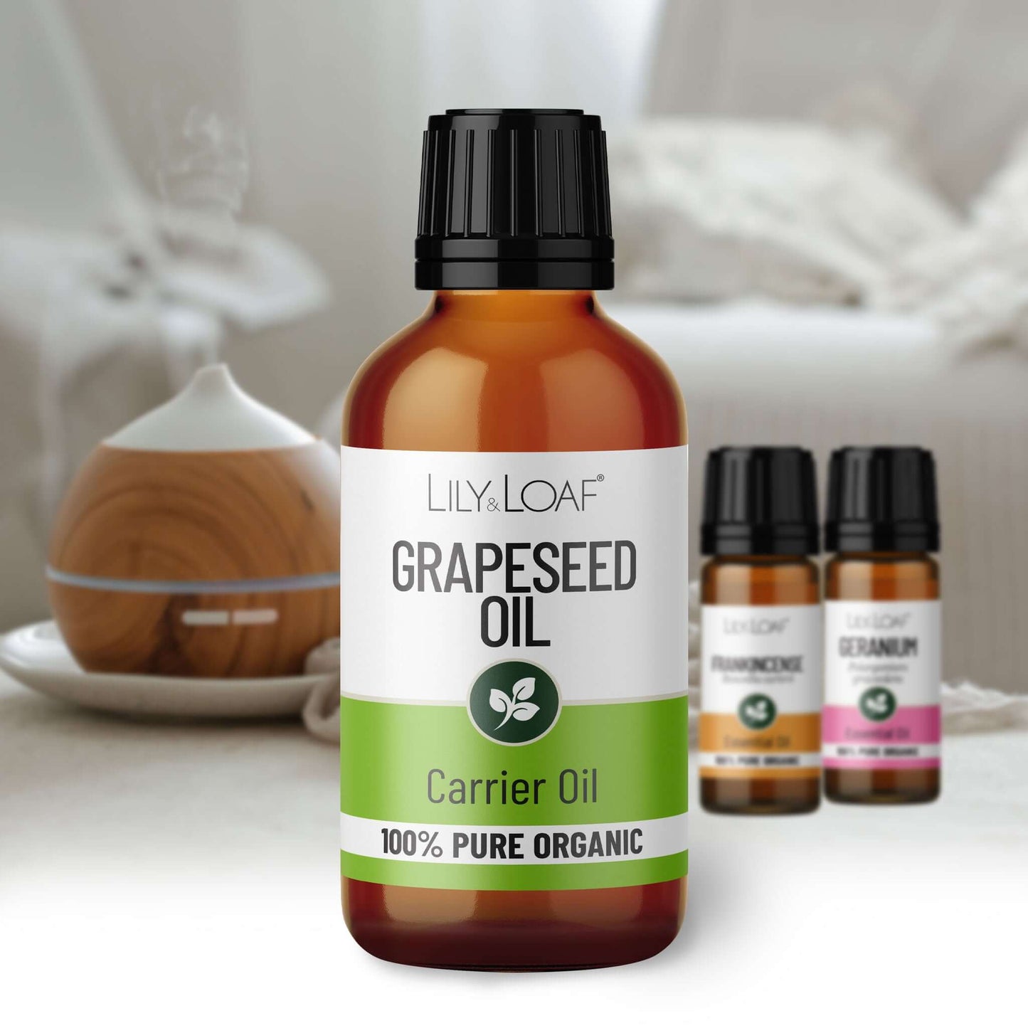 Bottle of Lily & Loaf Grapeseed Oil with a diffuser in the background