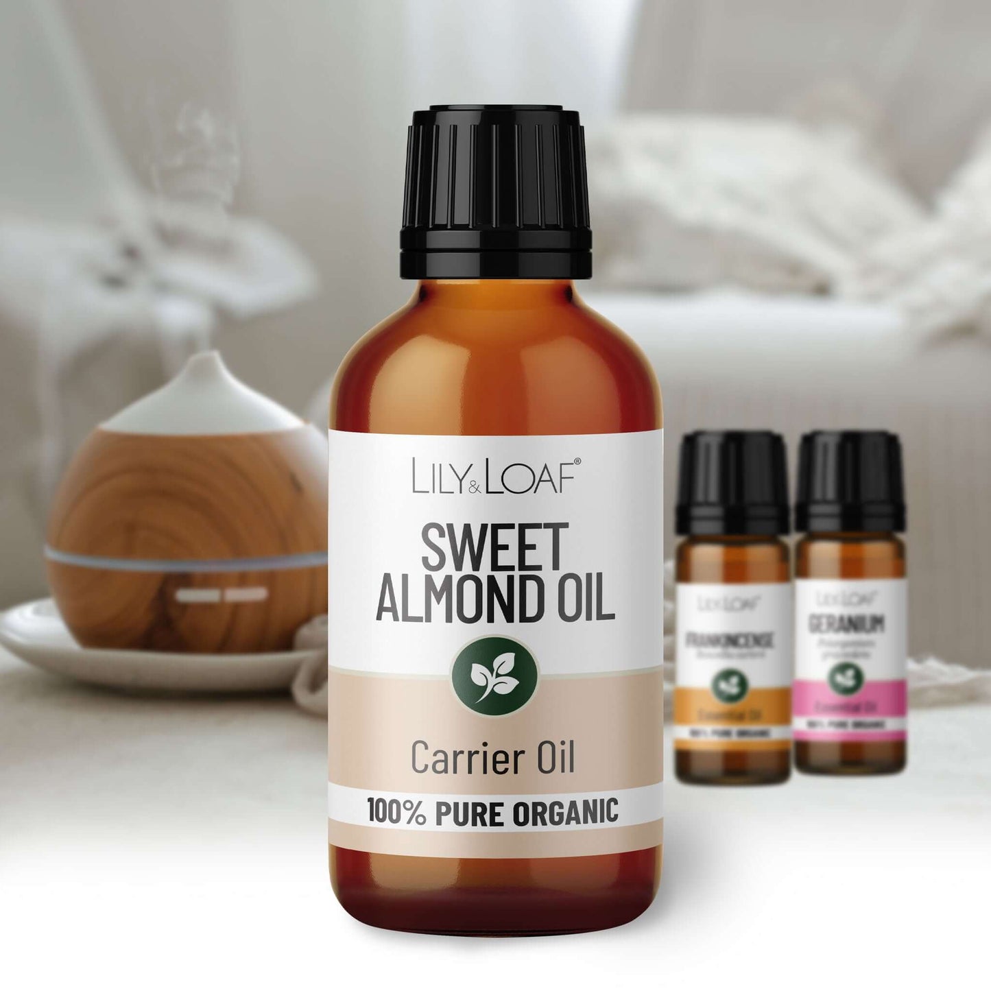 Bottle of Lily & Loaf Sweet Almond Oil with other oil bottles in the background.