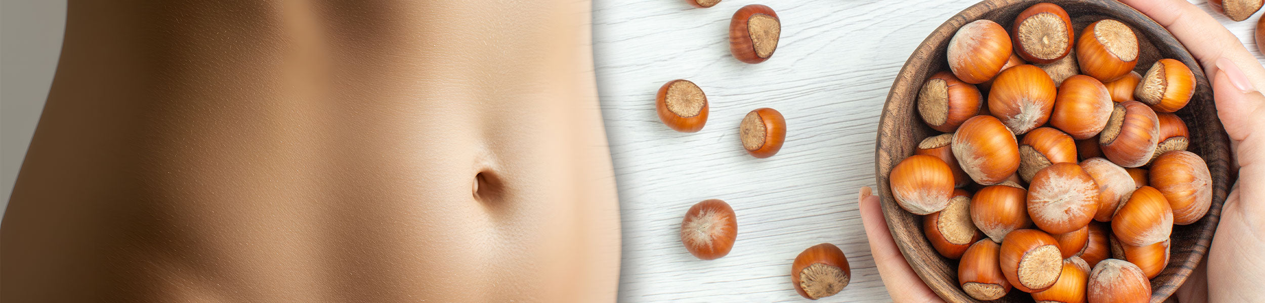 Close-up of a person's belly next to a bowl of hazelnuts on a light background