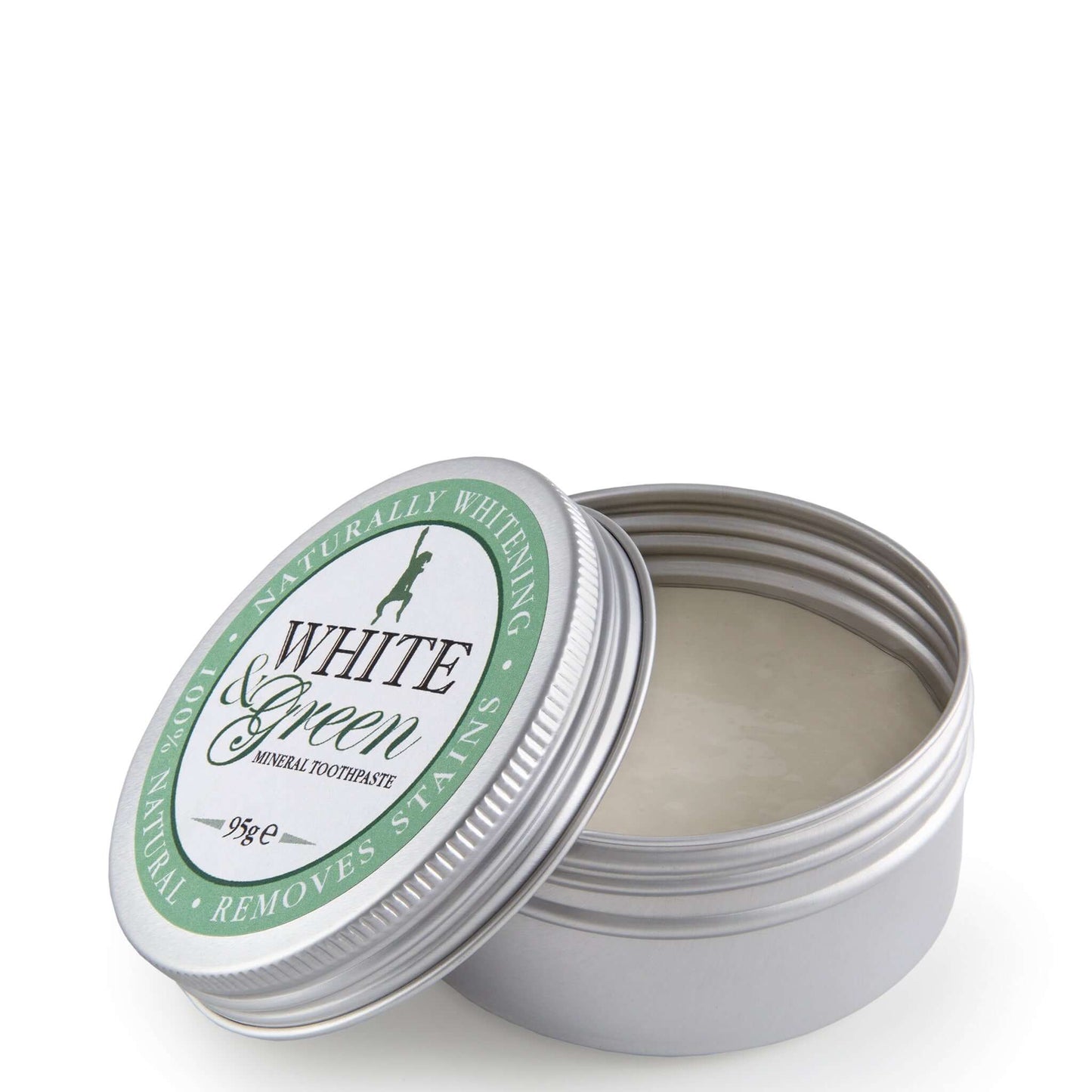 Open tin of White & Green mineral toothpaste with silver lid and green label, showing smooth, creamy paste inside.