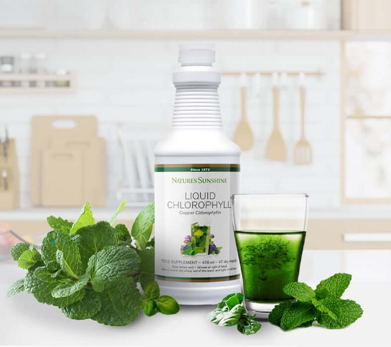 Nature's Sunshine Liquid Chlorophyll surrounded by mint leaves and a glass of water