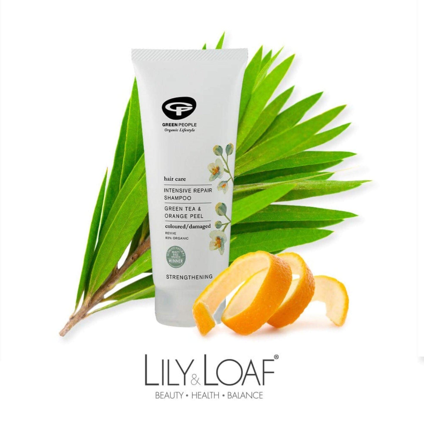Green People Intensive Repair Shampoo surrounded by green tea leaves and orange peel, botanicals included in the formula