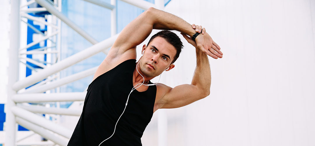 Fit man stretching outdoors, symbolising the role of the structural system, including muscles and bones, in maintaining physical strength and flexibility