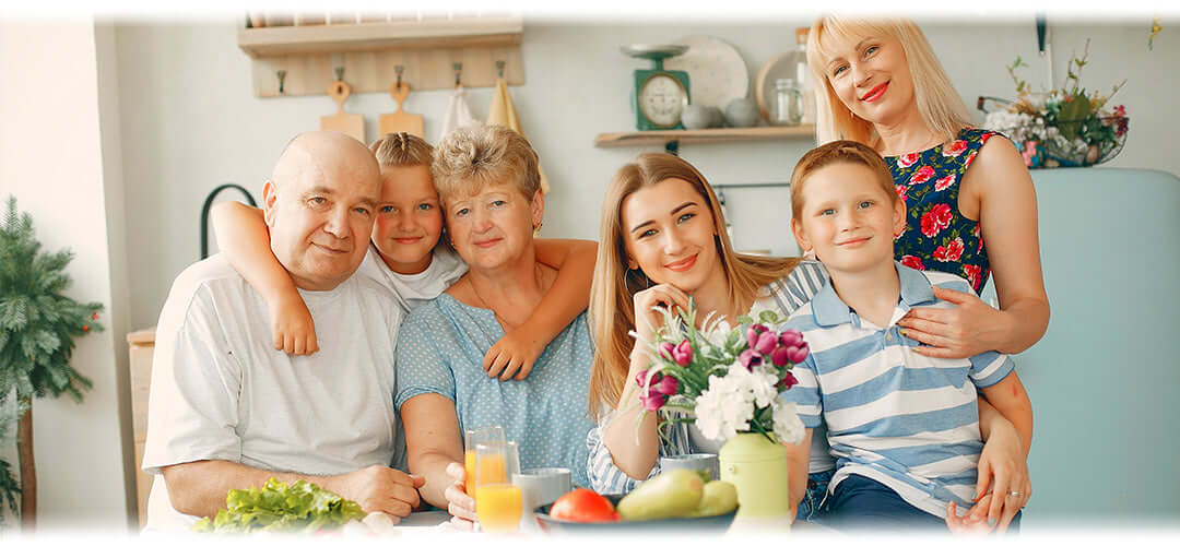 A happy family sitting together indoors, smiling and healthy