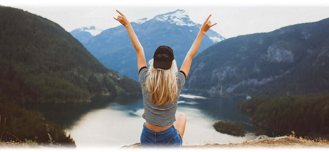 A vibrant natural landscape with mountains, forests, and flowing rivers.