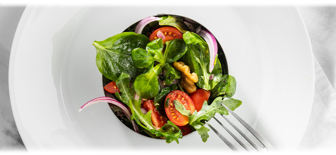A white plate with a health garden salad