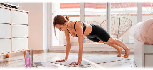 A woman in workout gear exercising at home
