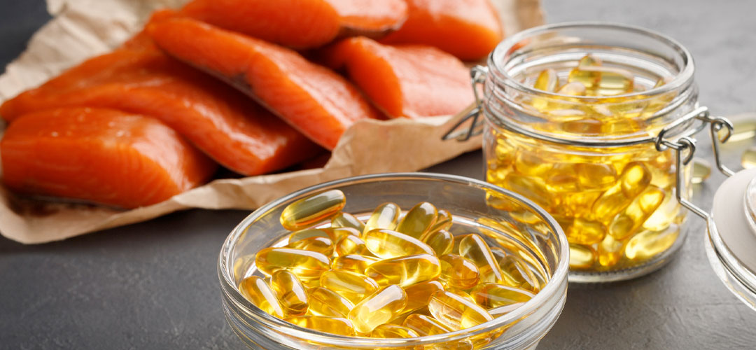 Fresh salmon and jars of omega-3 capsules, highlighting the benefits of fish oil and flaxseed oil for heart health and overall wellness