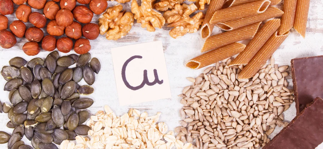 Selection of copper-rich foods including seeds, nuts, whole grains, and dark chocolate, highlighting their role in health and essential nutrient intake