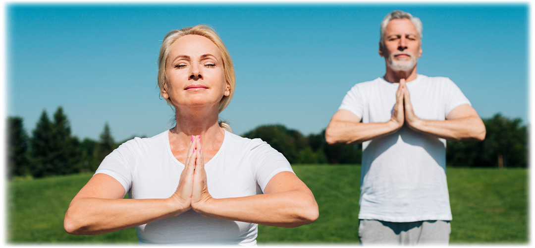 Couple practicing yoga outdoors, promoting relaxation, antioxidant benefits, and the role of Organic NAC 600 in overall wellness