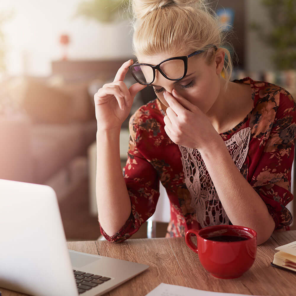 Stressed female sat at office desk