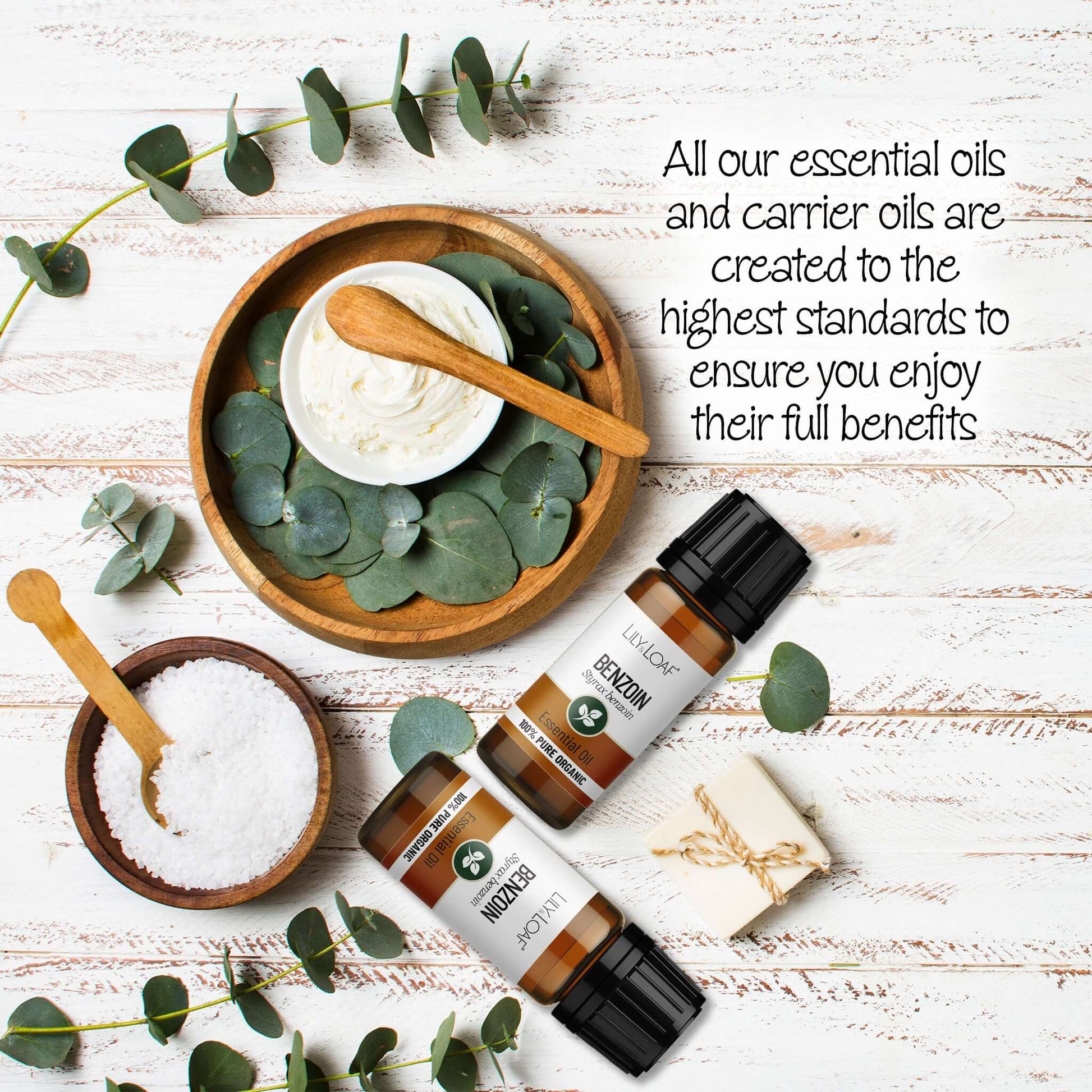 Benzoin Essential oils with eucalyptus leaves on a wooden surface