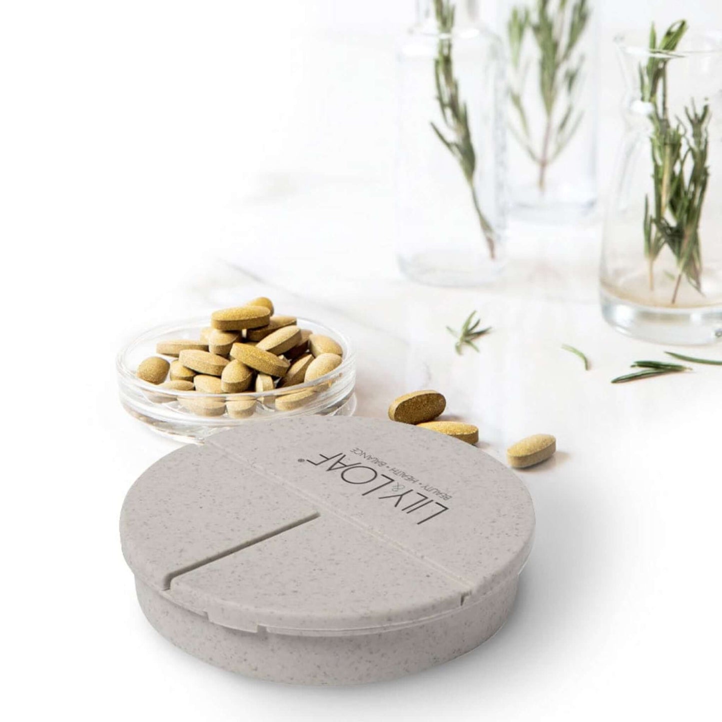 Lily & Loaf Capsule Box surrounded by tablets and capsules