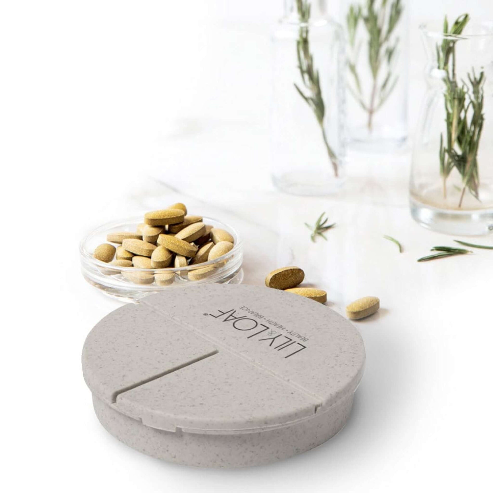 Lily & Loaf Capsule Box surrounded by tablets and capsules