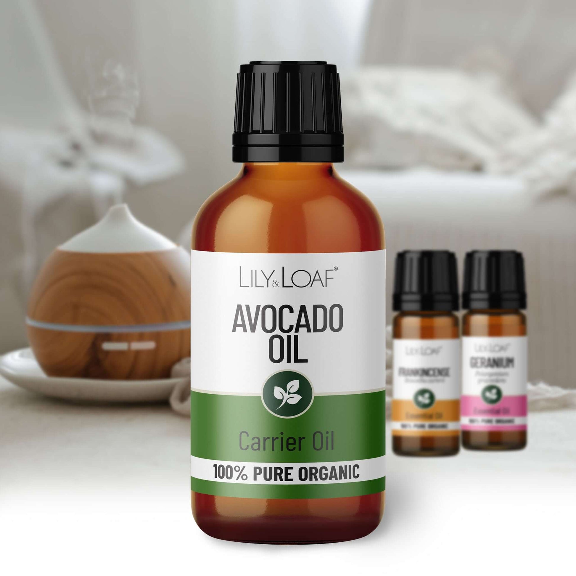 Bottle of Lily Loaf Avocado Oil with a diffuser in the background