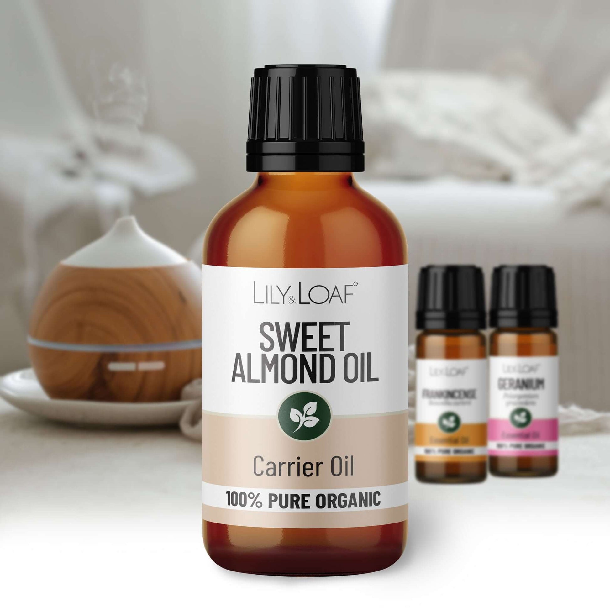 Bottle of Lily & Loaf Sweet Almond Oil with other oil bottles in the background.