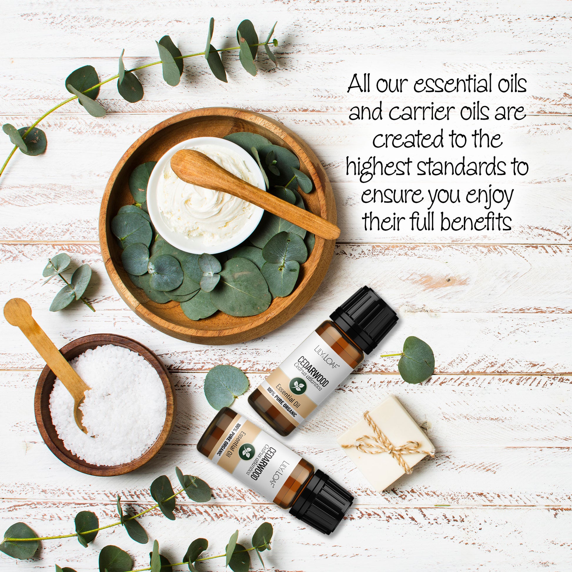 Cedarwood Atlas Organic Essential Oil surrounded by wooden bowls filled with moisturising cream