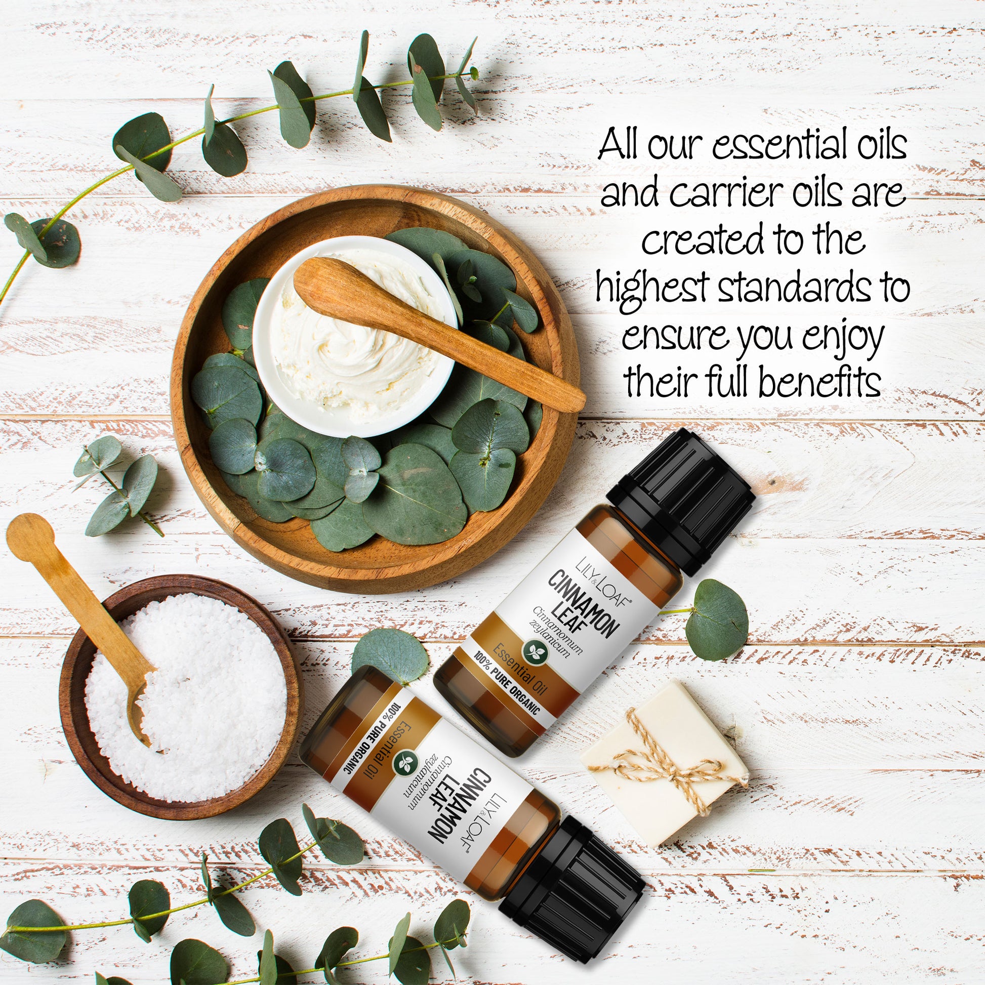 Lily & Loaf Cinnamon Leaf Organic Essential Oil surrounded by wooden bowls filled with moisturising cream