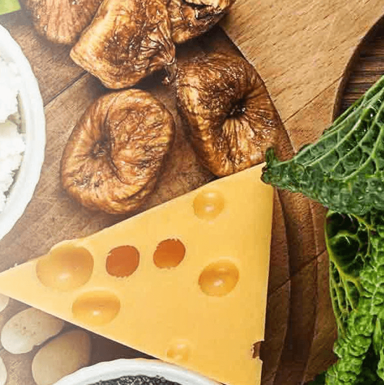 A selection of calcium rich foods including dairy and green leafy vegetables