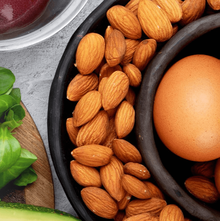 A selection of foods rich in CoQ10 including almonds and eggs