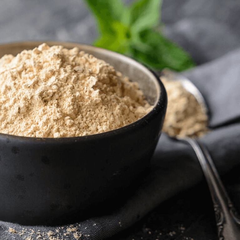 Maca powder in a black bowl