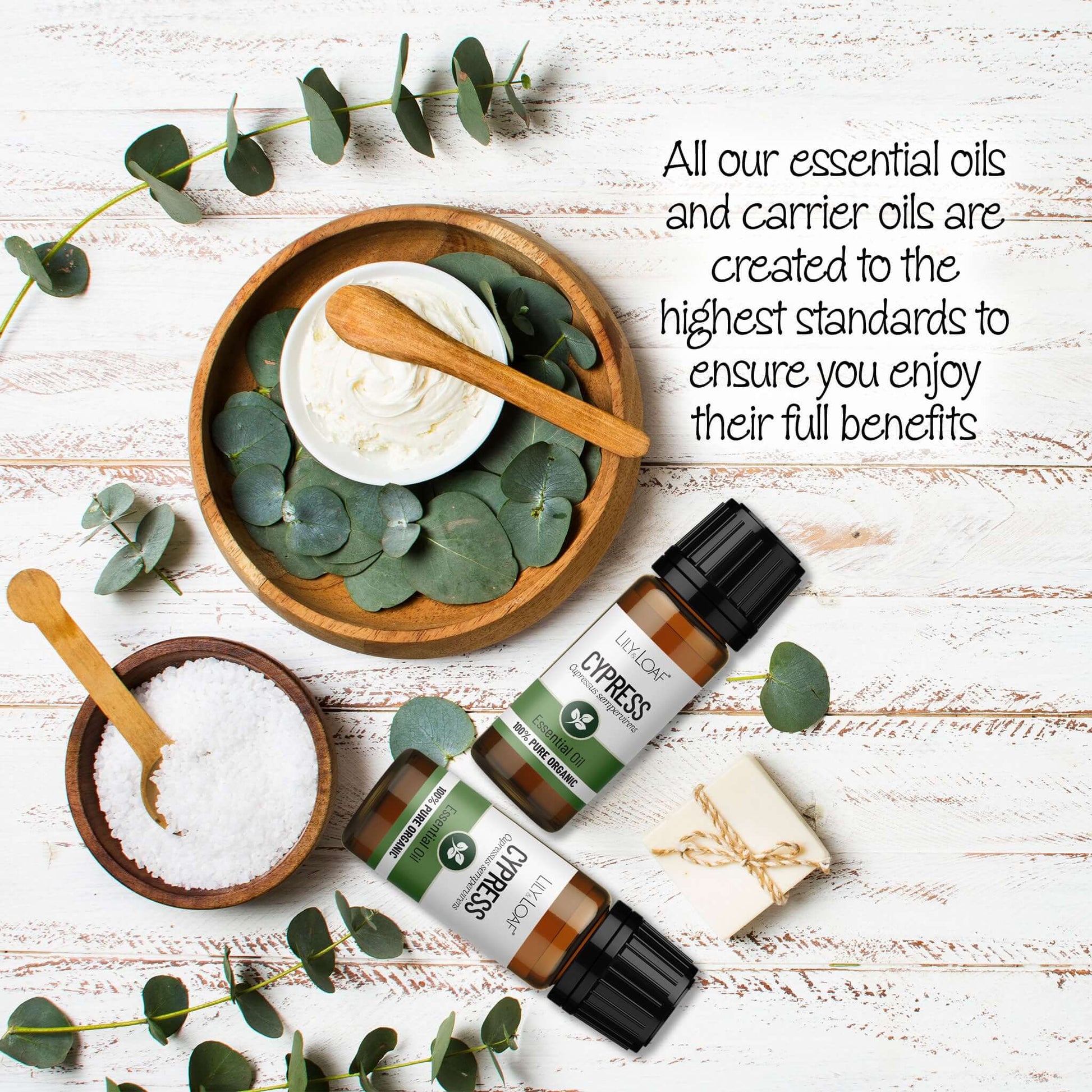 Cypress Essential oils with eucalyptus leaves on a wooden surface