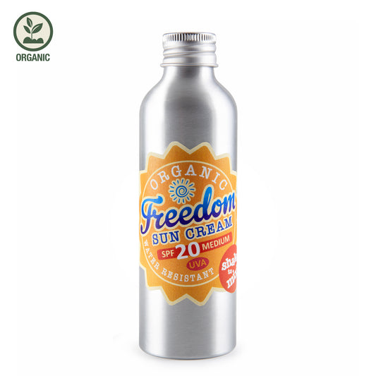 Metallic bottle of Organic Freedom Sun Cream SPF 20 on a white background