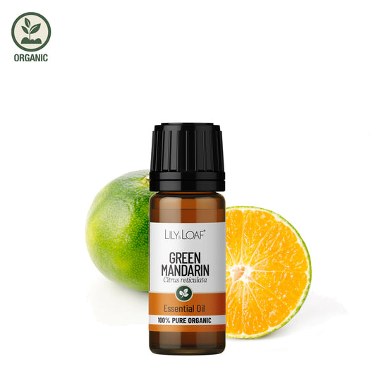 Bottle of Lily & Loaf Green Mandarin essential oil with a green and orange fruit on a white background
