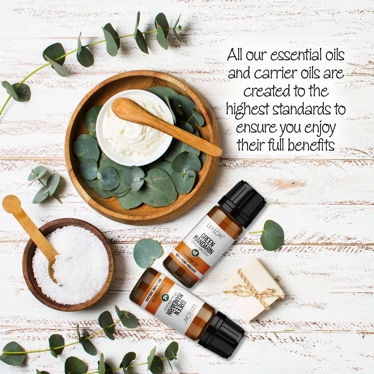 Green Mandarin Essential oil with eucalyptus leaves on a wooden surface