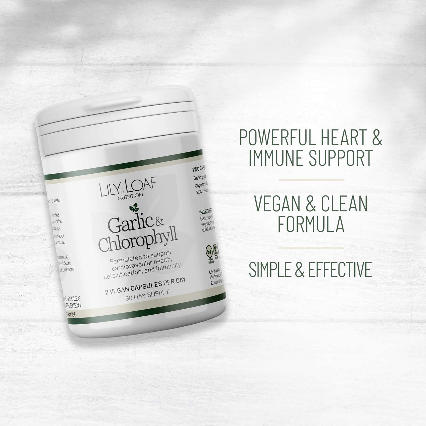 Lily & Loaf Garlic & Chlorophyll supplement pot, angled on a white wood background, highlighting vegan, heart, and immune support benefits.