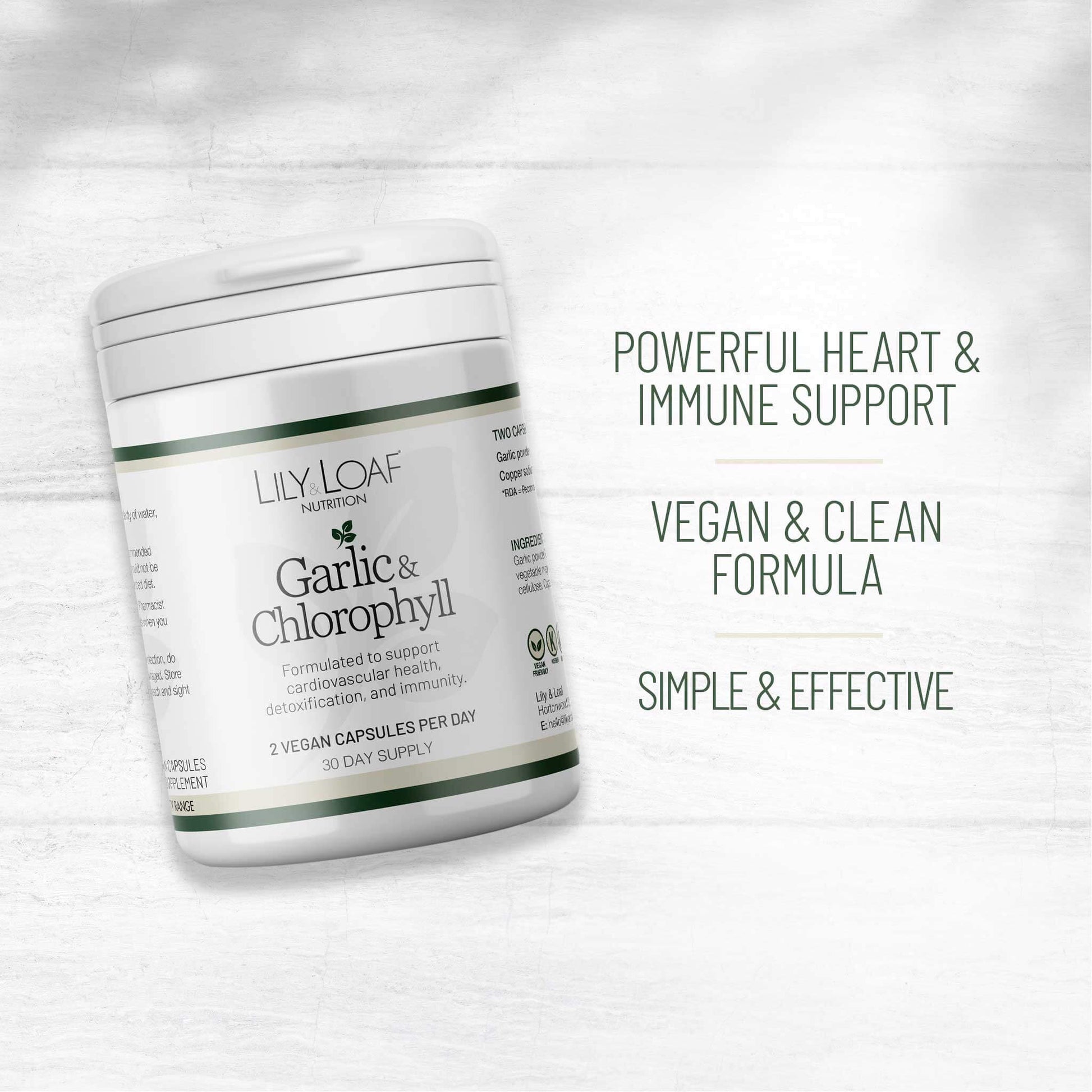 Lily & Loaf Garlic & Chlorophyll supplement pot, angled on a white wood background, highlighting vegan, heart, and immune support benefits.