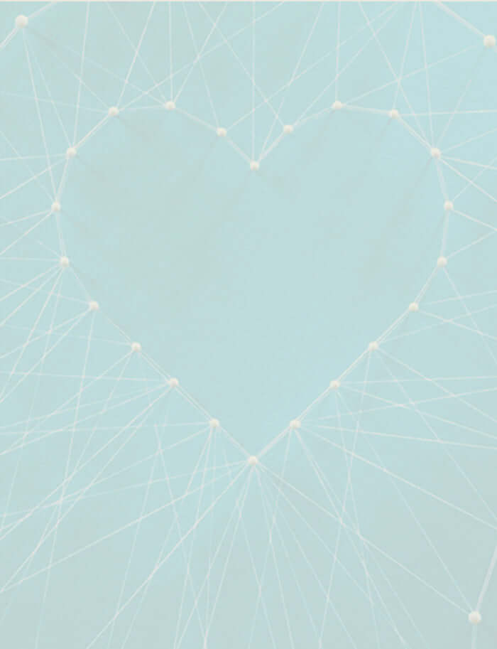 A string and pin diagram making a love heart shape