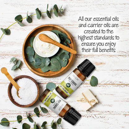 May Chang Essential Oils with eucalyptus leaves on a wooden surface