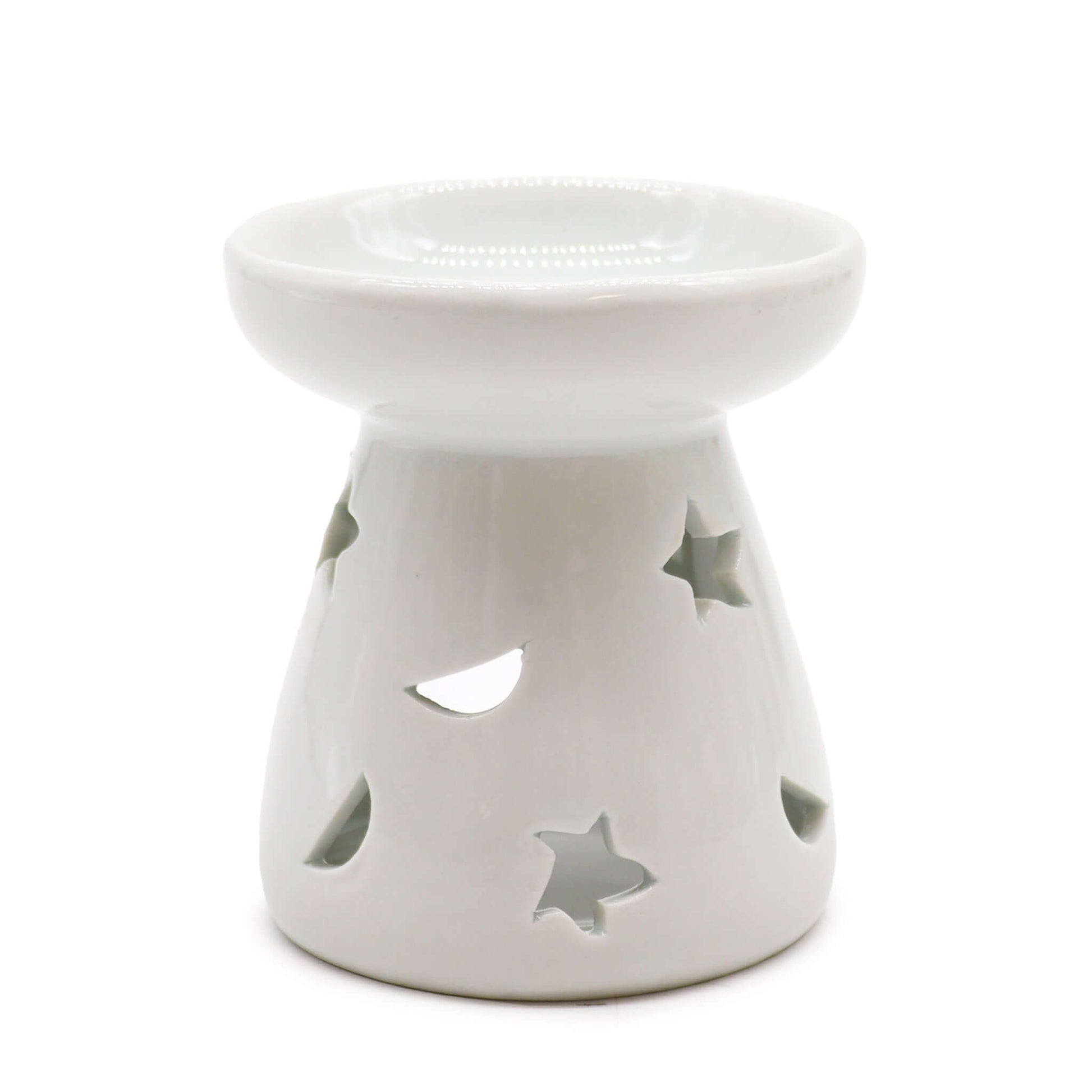 A white ceramic aromatherapy oil warmer with cut-out stars and a moon design.