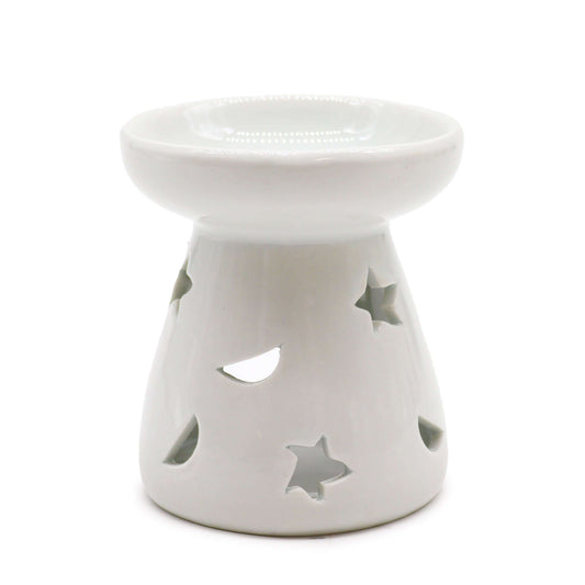 A white ceramic aromatherapy oil warmer with cut-out stars and a moon design.