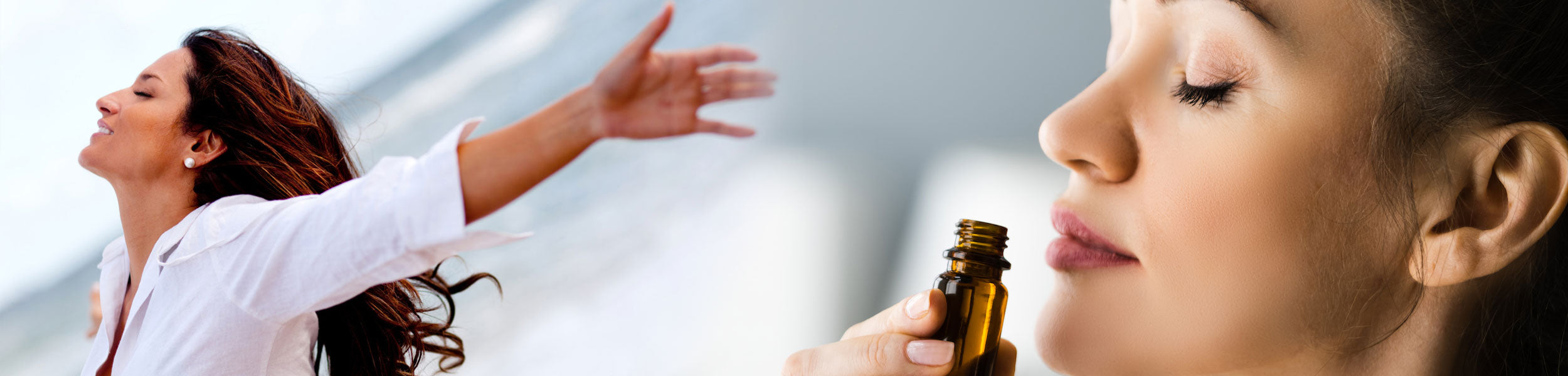 Woman holding a bottle of perfume with another woman closing her eyes and leaning in.