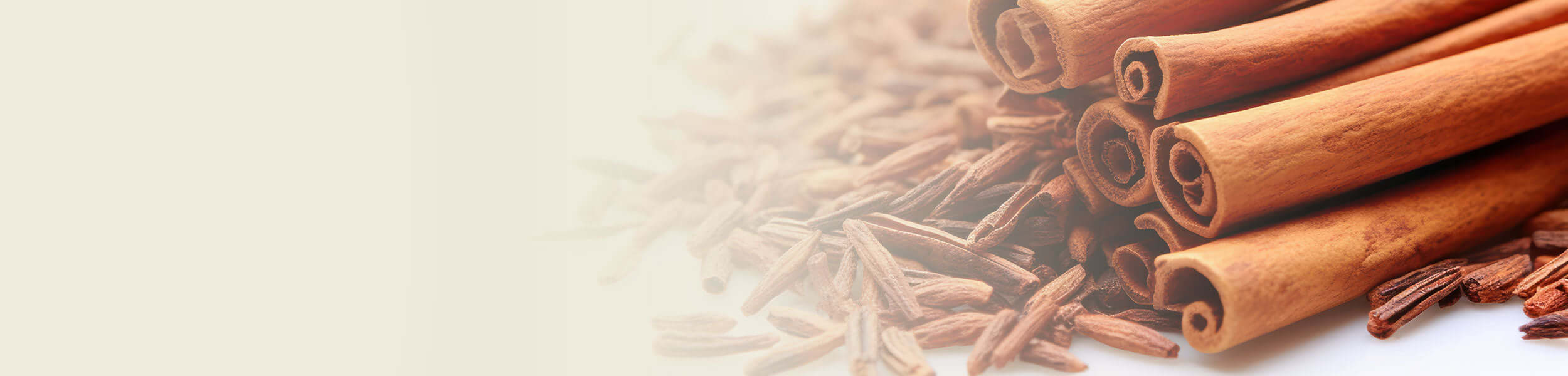 Aromatic Ho Wood sticks with a warm brown hue, surrounded by finely cut wood shavings, used in essential oil extraction.
