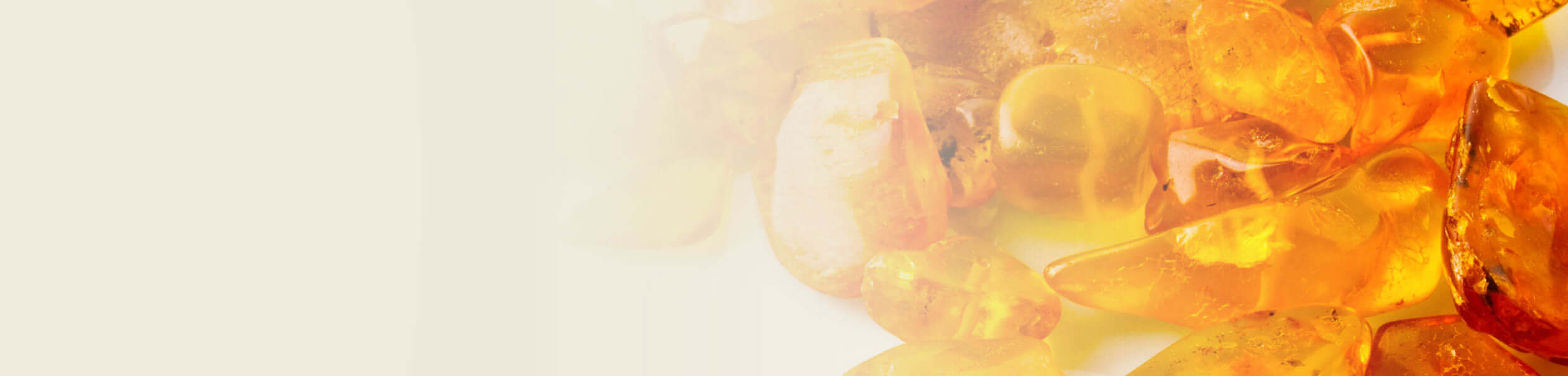Golden myrrh resin pieces with a glossy, amber-like texture, reflecting warm light.