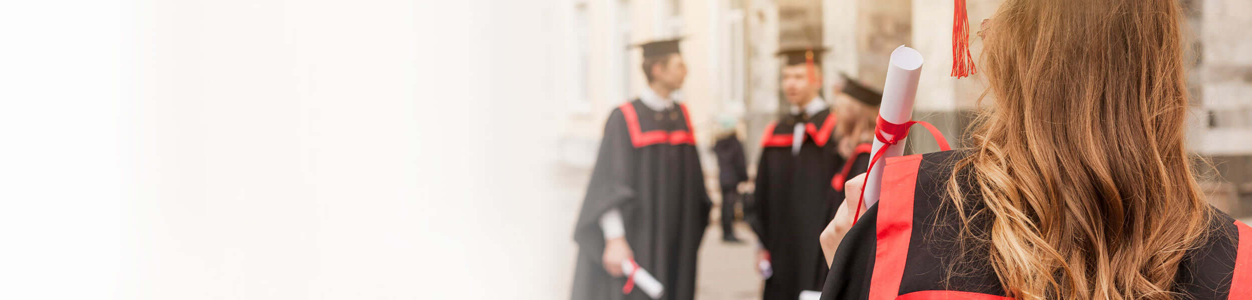 University Students wearing robes and mortar boards, collecting their degrees.