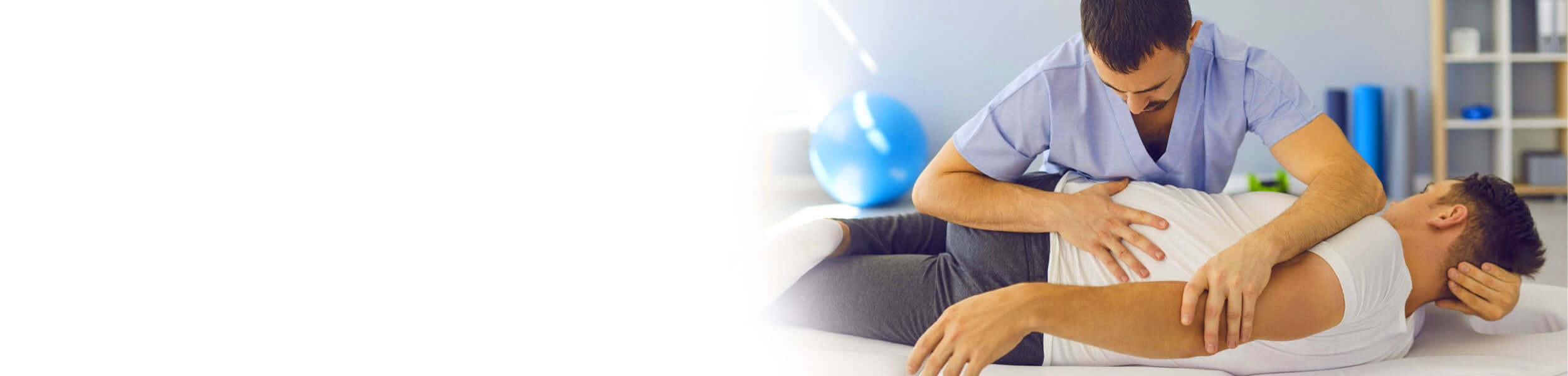 Osteopath performing a manual therapy treatment on a patient's back in a clinical setting.