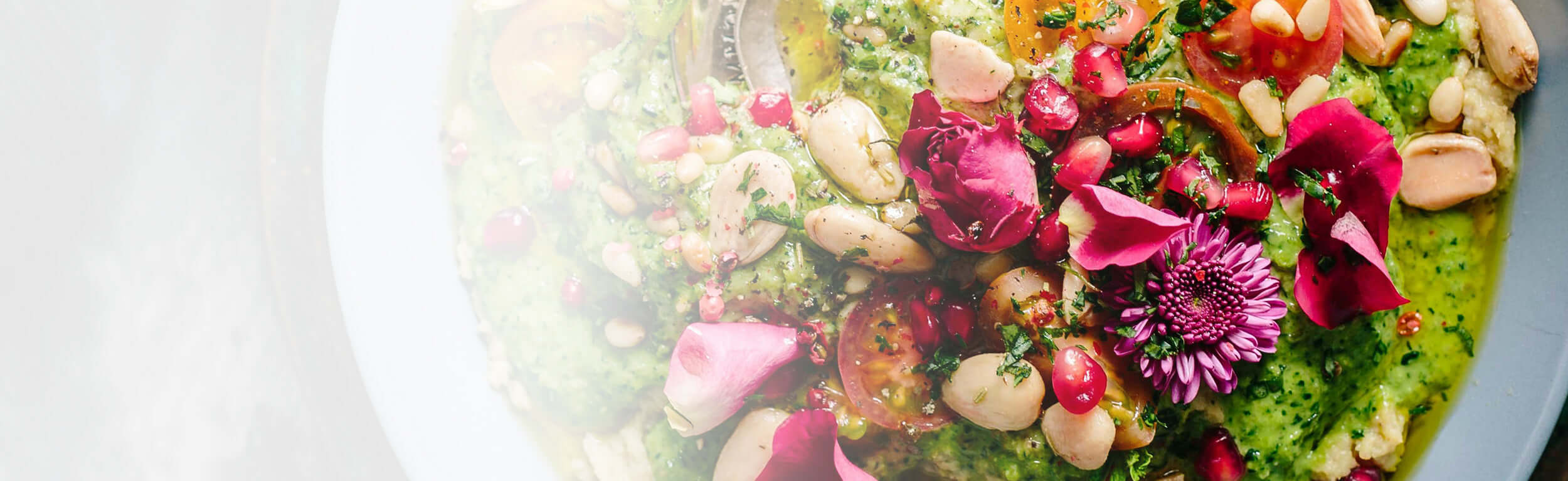 A delicious looking vegan dahl decorated with edible pink flowers