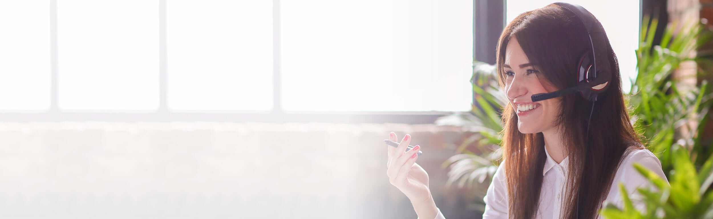 A woman in an office talking on a headset