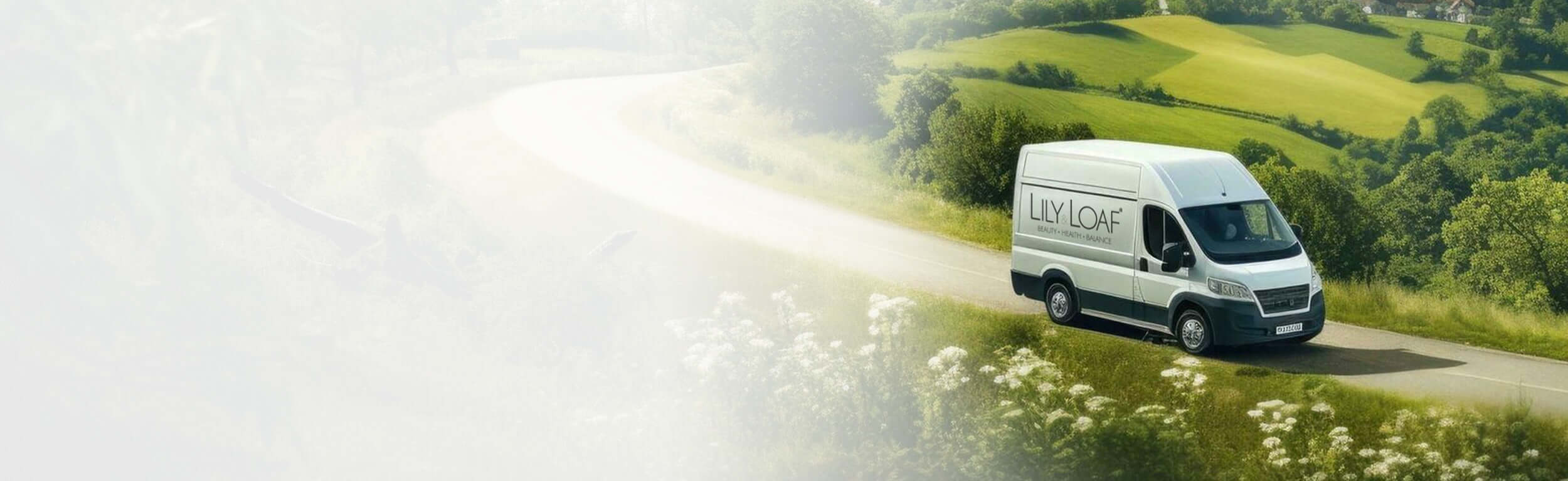 A van with Lily & Loaf signage driving through the coutryside