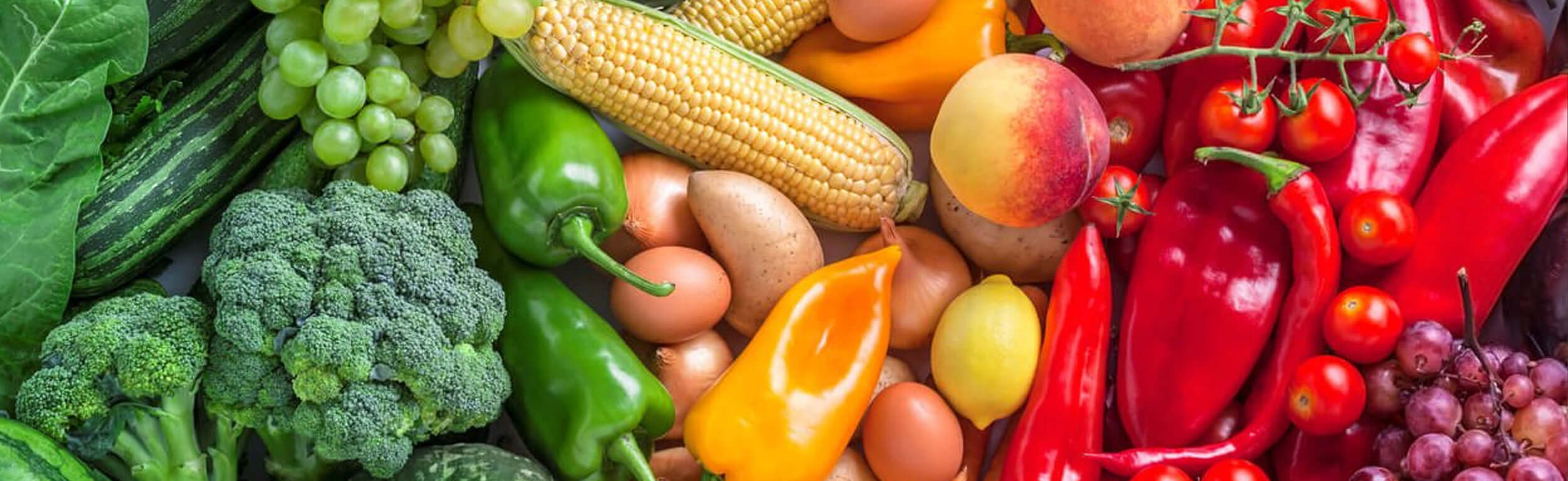 a rainbow of fruit and vegetables on a table