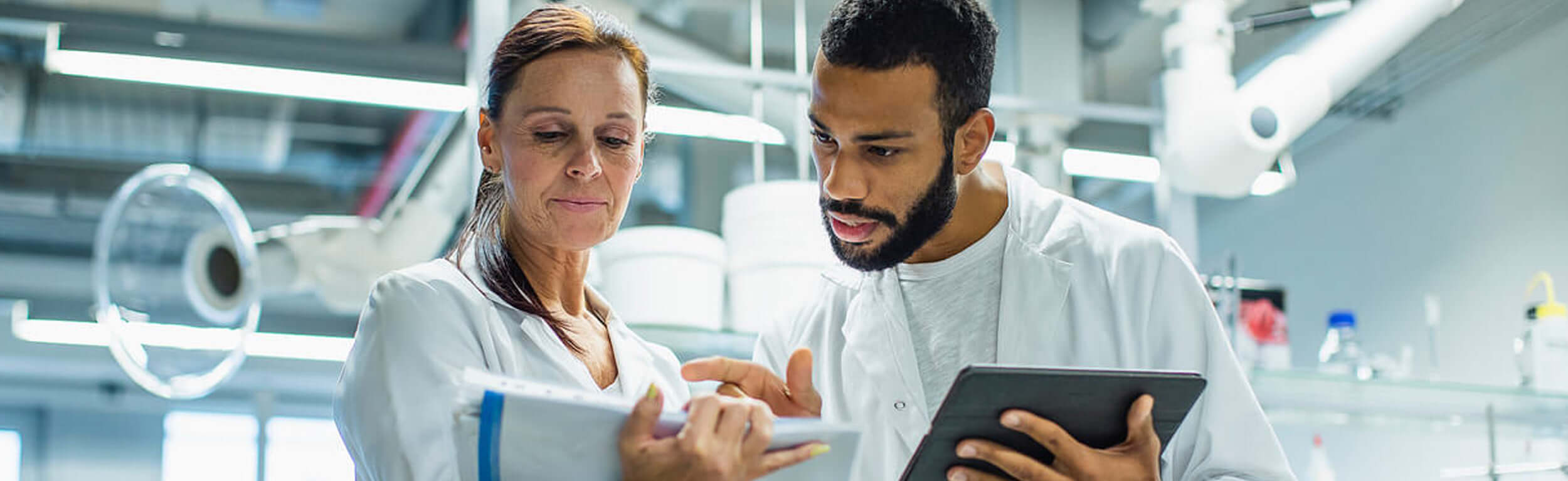 laboratory workers looking at data print outs