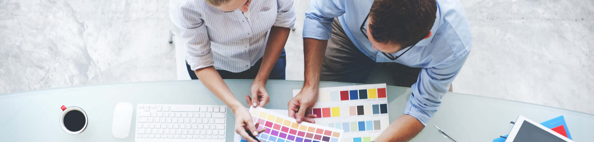 Office workers looking at printed pantone reference colours