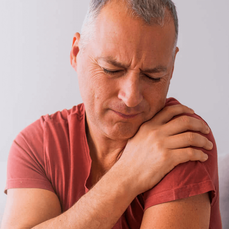 A man suffering from shoulder pain indicating an issue with his joints.
