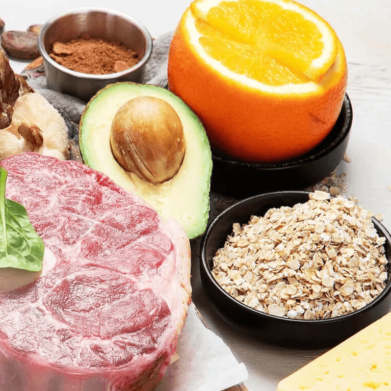 Variety of mineral-rich foods including steak, avocado, orange, oats, and mushrooms, highlighting the importance of minerals for health.