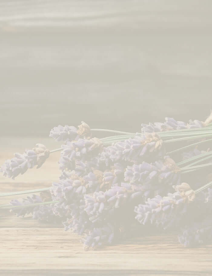 Close-up of aromatic lavandin flowers wrapped in twine, placed on a wooden background